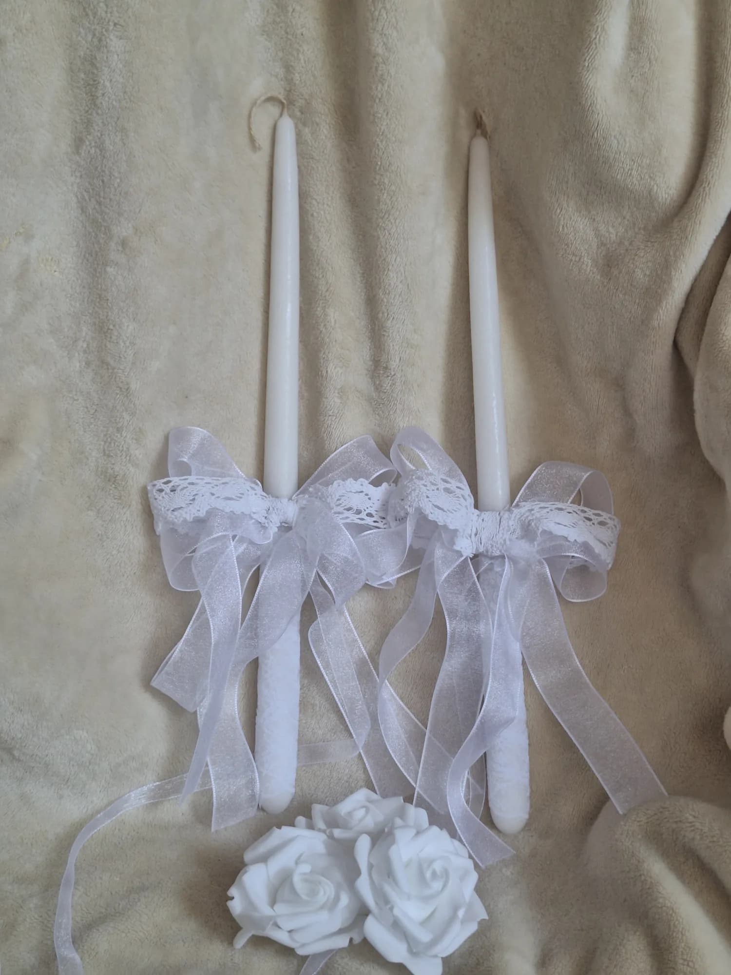 Ritual candles with white ornanza bows and lace.